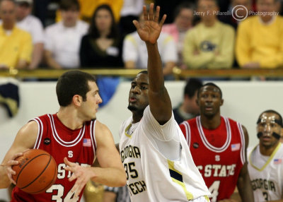 Yellow Jackets F Peacock gets a hand in the face of Wolfpack C McCauley