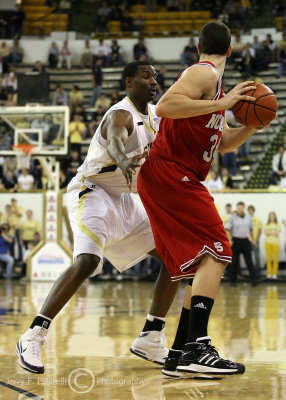 Jackets F Lawal holds Wolfpack C McCauley in check on defense