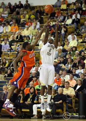 Jackets G Clinch puts up one of his six three point baskets as Tigers G K.C. Rivers attempts a block