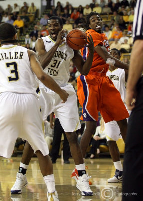 Yellow Jackets F Lawal grabs an defensive rebound away from Tigers C Raymond Sykes