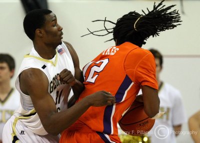 Yellow Jackets F Lawal bodies up on Tigers C Sykes as he turns toward the basket