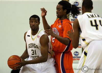 Jackets F Lawal works under the basket against Tigers C Sykes