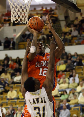 Yellow Jackets F Lawal holds his ground as Tigers C Sykes takes a short jumper