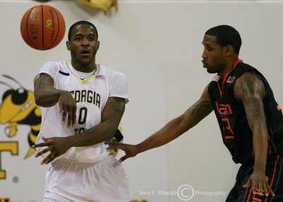 Georgia Tech G Lewis Clinch passes to a teammate while being guarded by Miami G James Dews