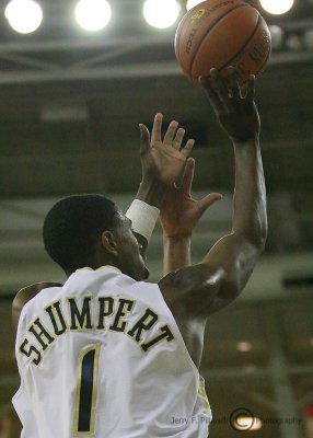 Jackets G Shumpert takes a jump shot over the outstretched arm of a Canes defender