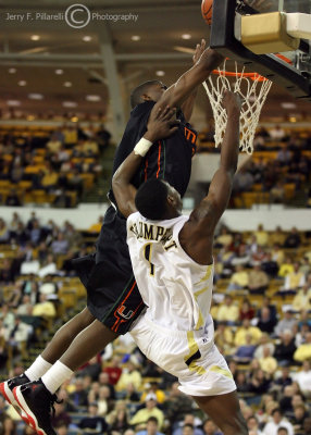 Jackets G Shumpert takes a hard foul from Canes G DeQuan Jones while going in for a layup
