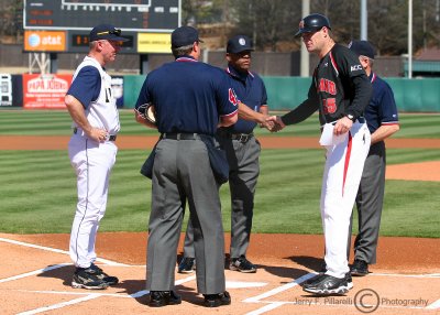 Yellow Jackets Head Coach Danny Hall meets with umpires and Maryland Head Coach Terry Rupp prior to the game
