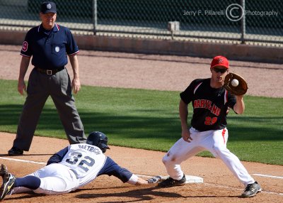 Yellow Jackets SS Derek Dietrich dives back into first as the pickoff throw comes to Maryland 1B Curtis Lazar