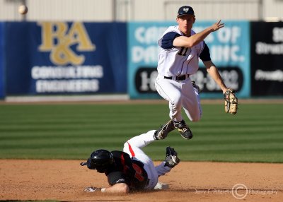 Georgia Tech SS Evan Martin leaps over sliding Terrapins 3B Mike Murphy to complete the throw to first