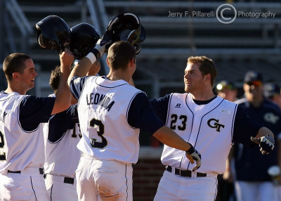 Jackets LF Matt Simonds is welcomed home by teammates after his late inning home run