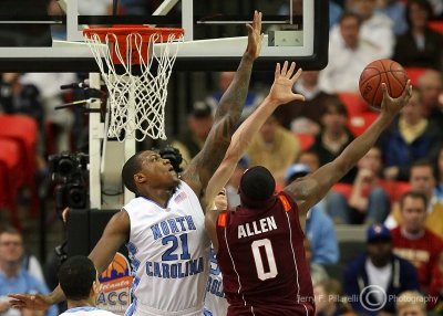Tar Heels F Deon Thompson goes up to attempt to block the drive of Hokies F Jeff Allen