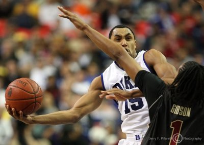 Blue Devils G Gerald Henderson scoops a shot around Seminoles F Xavier Gibson