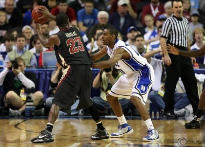 Blue Devils G Elliot Williams squares up on defense against FSU G Douglas