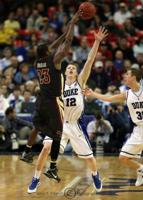 Blue Devils F Singler leaps to try and disrupt the skip pass by Seminoles G Douglas