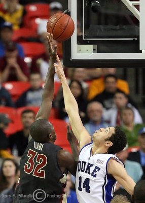 Duke F David McClure tries to block the short hook by Florida State C Alabi