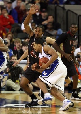 FSU F Reid attempts to stop driving Duke G Henderson