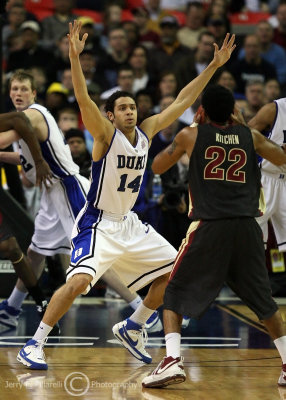 Blue Devils F McClure gets his hands up on defense while guarding FSU G Derwin Kitchens