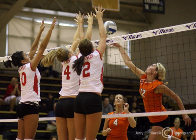 Mercer OH Rachel Urbelis attempts to tip the ball over a wall of Austin Peay blockers