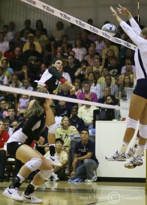 Tech players attempt to block the spike of Bulldogs OH Erika Clark