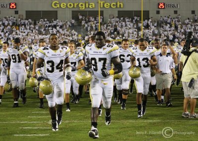 Yellow Jackets team members run to the north end zone to celebrate with fans after the victory over Clemson