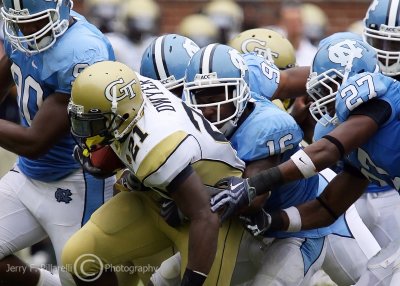 Yellow Jackets B-back Jonathan Dwyer attempts to break away from a pack of Tar Heels defenders