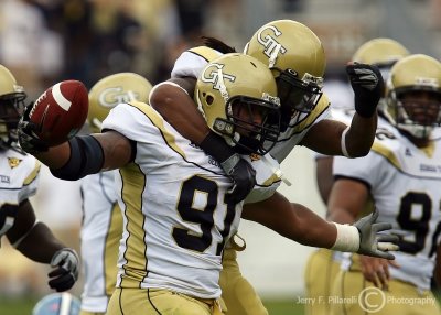 Jackets DE Morgan celebrates his fumble recovery with S Morgan Burnett