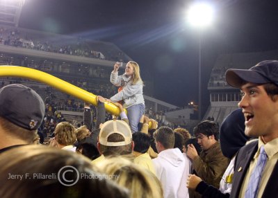Tech fan catches a ride on the goal post as it moves downfield