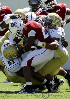 Georgia Tech LB Brad Jefferson gets help pulling down Bulldogs RB Massey