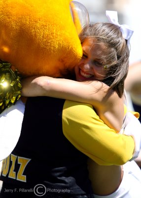 Yellow Jackets cheerleader gets a hug from Buzz