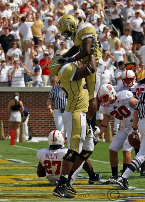 Jackets A-back Orwin Smith gets lifted in the air by OT Nick Claytor to celebrate his touchdown dive