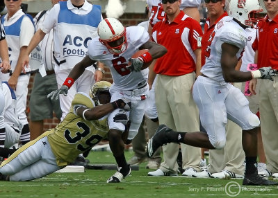 Jackets S Fred Holton pulls down Wolfpack WR TJ Graham