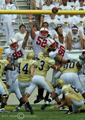 Jackets PK Scott Blair drills the PAT over the reach of the Wolfpack defenders