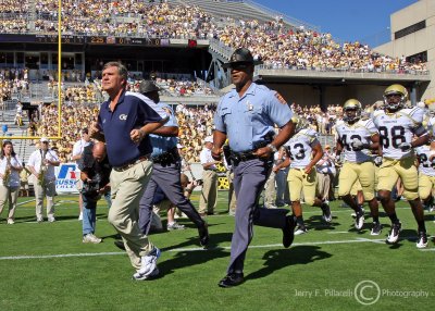 Georgia Tech Yellow Jackets Head Coach Paul Johnson leads his team onto the field