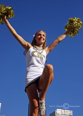Jackets Cheerleader works the top of the pyramid during a break in the action