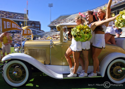 Jackets Cheerleaders and the Ramblin Wreck lead the team onto the field