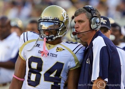 Georgia Tech Yellow Jackets Head Coach Paul Johnson delivers the next play to WR Tyler Melton