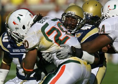 Yellow Jackets OLB Anthony Egbuniwe ties up Hurricanes RB Damien Berry at the line of scrimmage