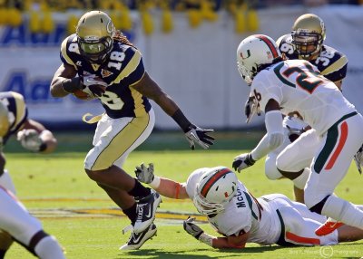 Yellow Jackets B-back Allen slips out of the grasp of Hurricanes LB Colin McCarthy