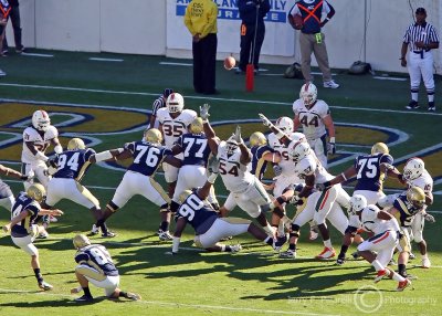 Yellow Jackets K Scott Blair kicks the PAT as the Miami defense breaks through the line