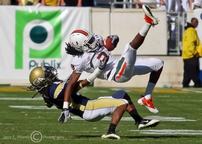 Jackets CB Mario Butler pulls down Canes WR Travis Benjamin after an acrobatic catch