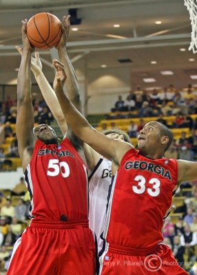 Bulldogs F Price and F Thompkins block out a Jackets player to secure a rebound