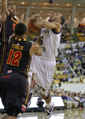 Jackets G Miller is fouled by Maryland G Stoglin on his way to the basket