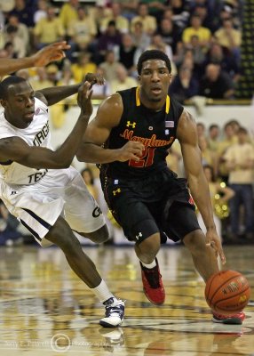 Yellow Jackets G Udofia fights through a screen to stay with Terrapins G Howard
