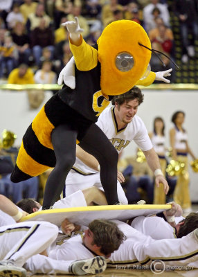 Jackets Mascot Buzz does some cheerleader surfing during a break in the action