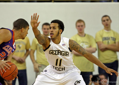 Yellow Jackets F Brian Oliver gets his had up while defending Tigers F Milton Jennings
