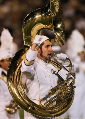 Georgia Tech tuba player cheers as the band leaves the field after halftime