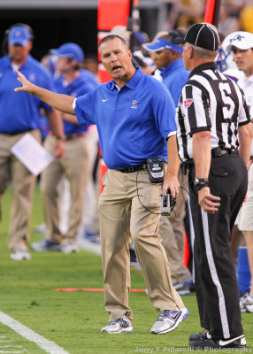 Presbyterian Blue Hose Head Coach Harold Nichols has a discussion with a referee