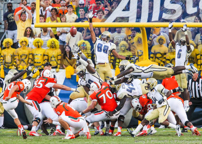 Georgia Tech defenders attempt to block a Miami extra point