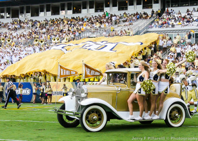 Tech Cheerleaders ride the Wramblin Wreck onto the field before the start of the third quarter