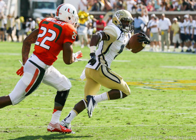 Yellow Jackets A-back Zenon runs ahead of Hurricanes DB Rodgers